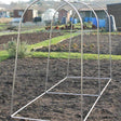 An empty aluminum hoop frame designed for use as a plant cage in a garden setting.