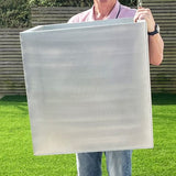 a man holding a silver aluzinc cube planter