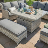 close image of rattan dining set with glass top table 2 benches total 9 seats on a patio dining table