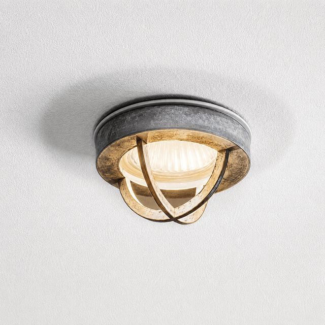 Ceiling light fixture with metallic design on a white ceiling