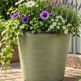 Light green pot with flowers outside