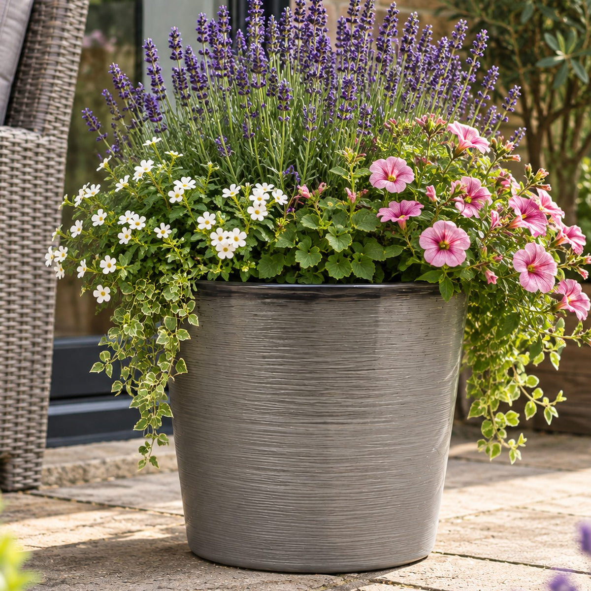Light grey pot outside with flowers