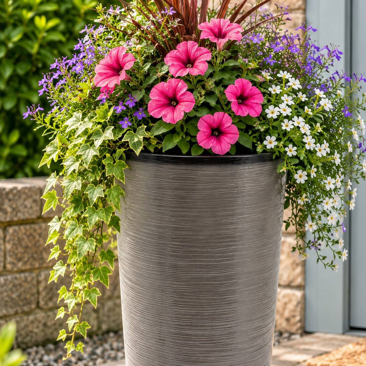 light grey tall planter with flowers