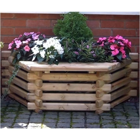 wooden flatback seat filled with flowers up against a brick wall