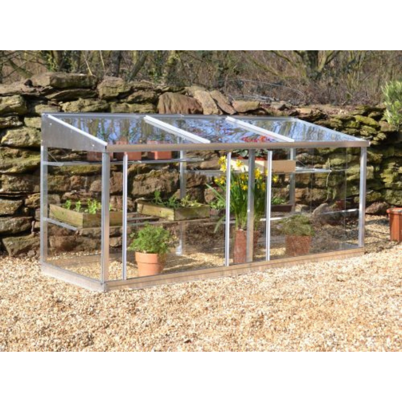 A half-sized greenhouse with a metal frame and clear glass panels, containing several potted plants.