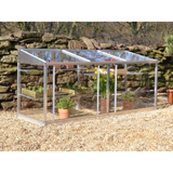 A half-sized greenhouse with a metal frame and clear glass panels, containing several potted plants.