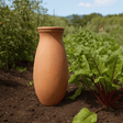 Terracotta water bottle in a garden setting