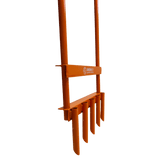 Orange agricultural orange aerator tool with multiple prongs on a black background