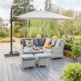 Corner sofa, table and 2 stools in beautiful garden on wooden patio