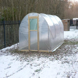 Polycarbonate greenhouse in a snowy backyard setting