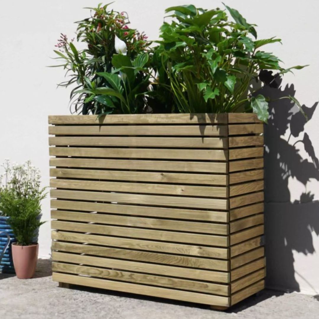 Tall wooden planter box with plants against a light background