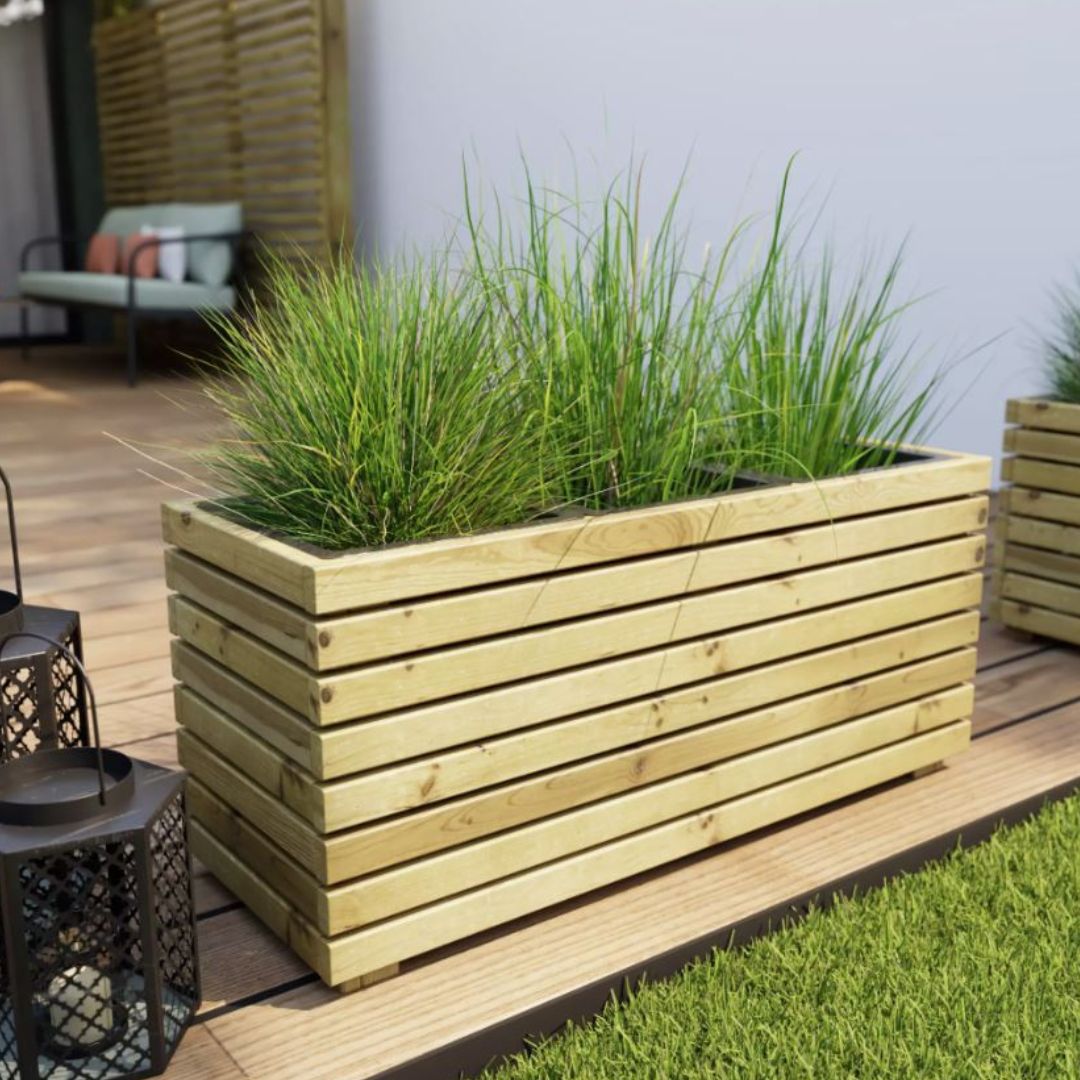 Standard wooden planter box with grass on a wooden deck