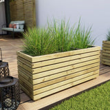 Standard wooden planter box with grass on a wooden deck