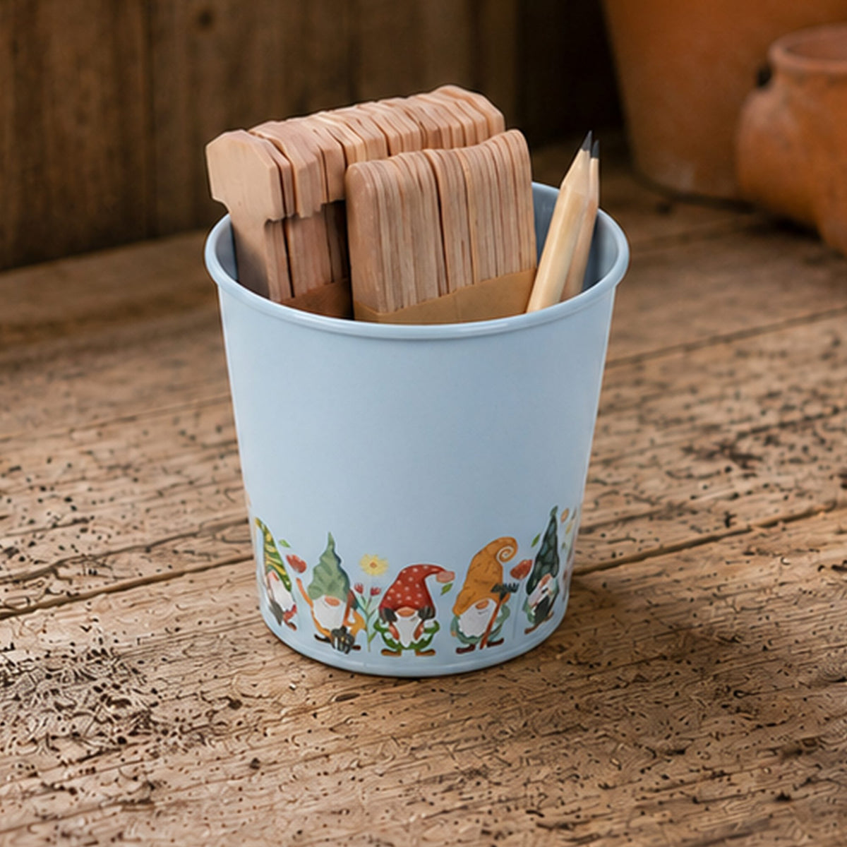 A light blue seed label tin with pencils and labels in