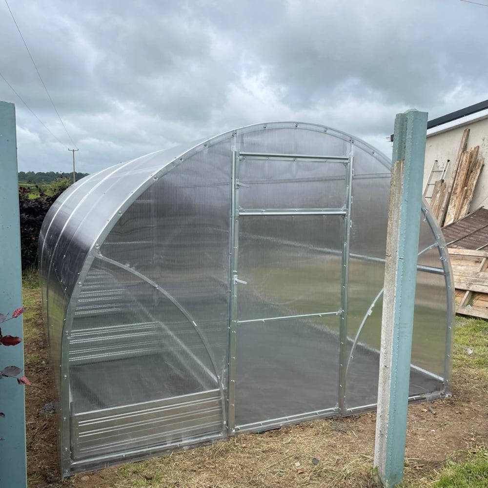 greenhouse polytunnel with planters inside