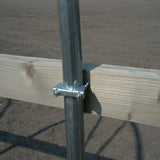Metal post with wooden beams on a dirt background