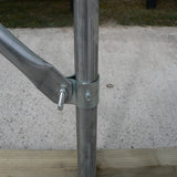 Metal pole with horizontal bar on a concrete surface