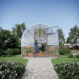Small greenhouse with transparent walls in a garden setting