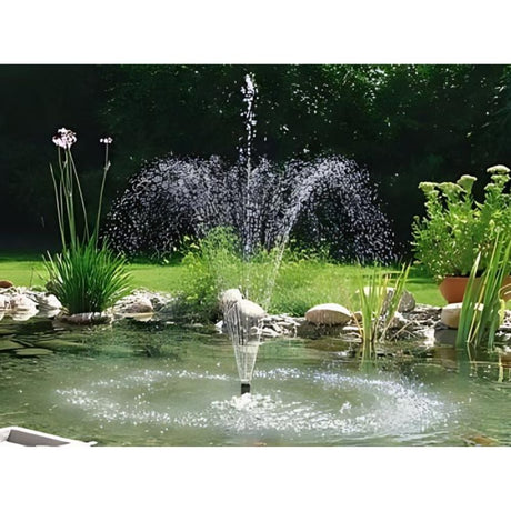 Tall garden pond fountain surrounded by rocks and plants