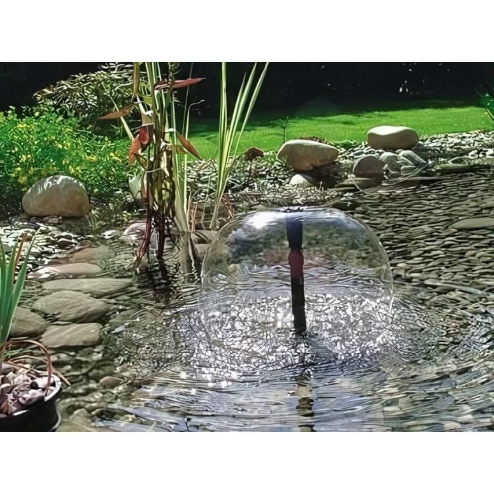 pump in a garden pond with plants and rocks fountain