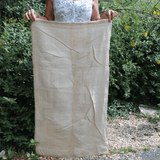 lady holding large sized potato sack