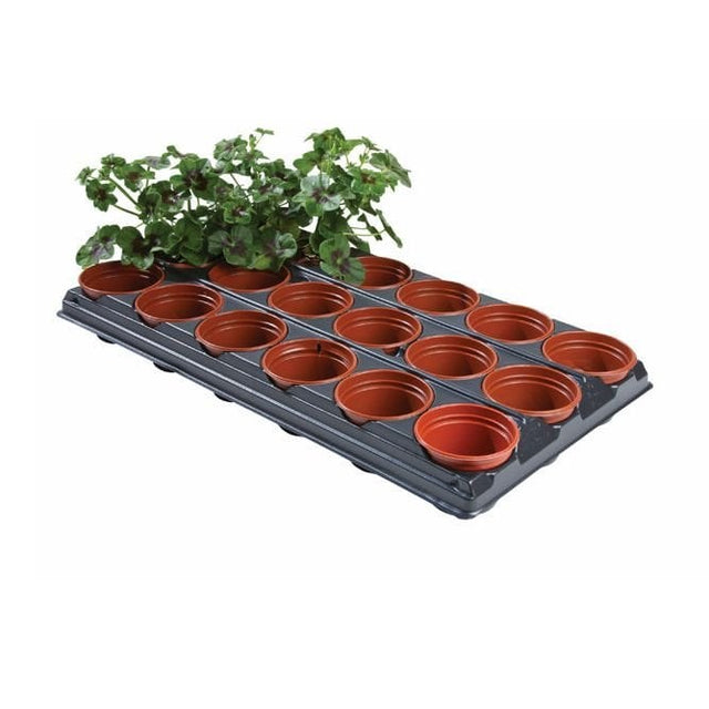 A black potting tray with 18 individual orange pots, some containing soil and green plants.