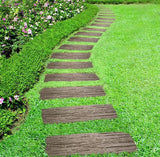 Railroad stepping stones on a grass lawn