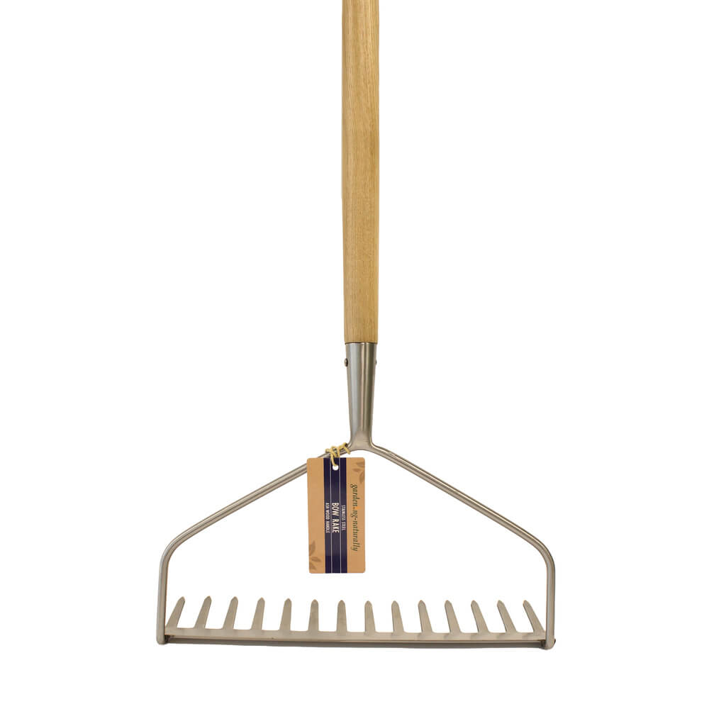 Garden rake with wooden handle on a white background