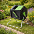 Black and green tumbling composter in a garden