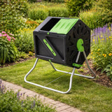 Black and green tumbling composter in a garden