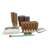 A seed-starting and gardening kit arranged on a white background, including stacked paper cone planters, stacked nursery pots, a tray of seed-starting cones, a bag of perlite, a small green-handled tool with an orange end, and a metal trowel.