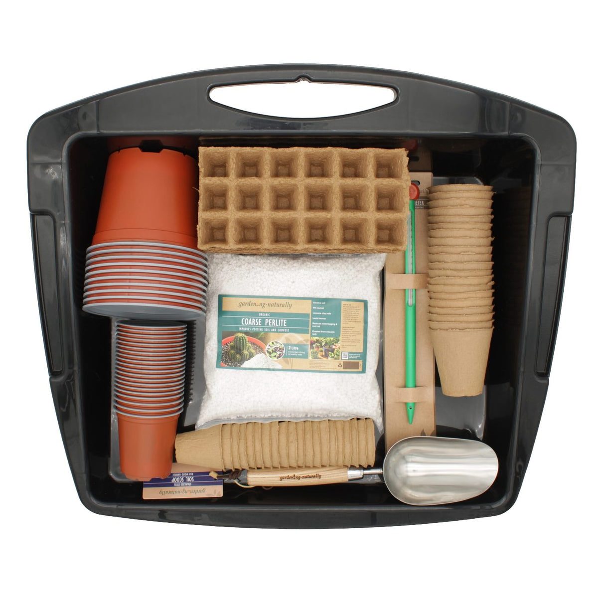 A gardening starter kit organized inside a black plastic storage tote. The kit includes terracotta-colored pots, brown paper seed-starting trays, a bag of compost, wooden plant markers, a metal scoop, a green-handled pencil, and other small gardening tools, all on a plain white background.