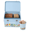 A light blue metal seed storage tin with an open lid, decorated with a row of colorful garden gnomes and the word 'Seeds' on the front. Inside, wooden seed tabs by months and a wooden 'Seeds' tab are organized.