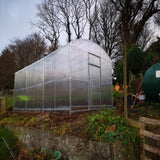 side view of a greenhouse in a garden on a grass ledge