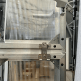 Close-up of a metallic machine component with a blurred background