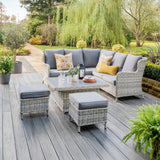Outdoor corner sofa with table and 2 stools on patio in garden