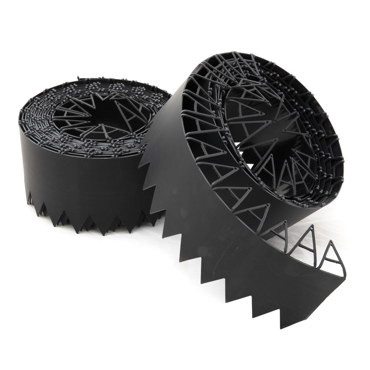 Rolls of black flexible lawn edging with a zigzag design, including securing pins.