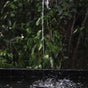 Solar fountain in pond with water coming out in a garden