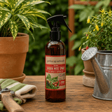 Spider mite spray bottle on a wooden table with gardening tools and plants.
