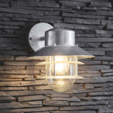 A silver Strand down light with a industrial caged design, mounted on an exterior wall with a stone finish.