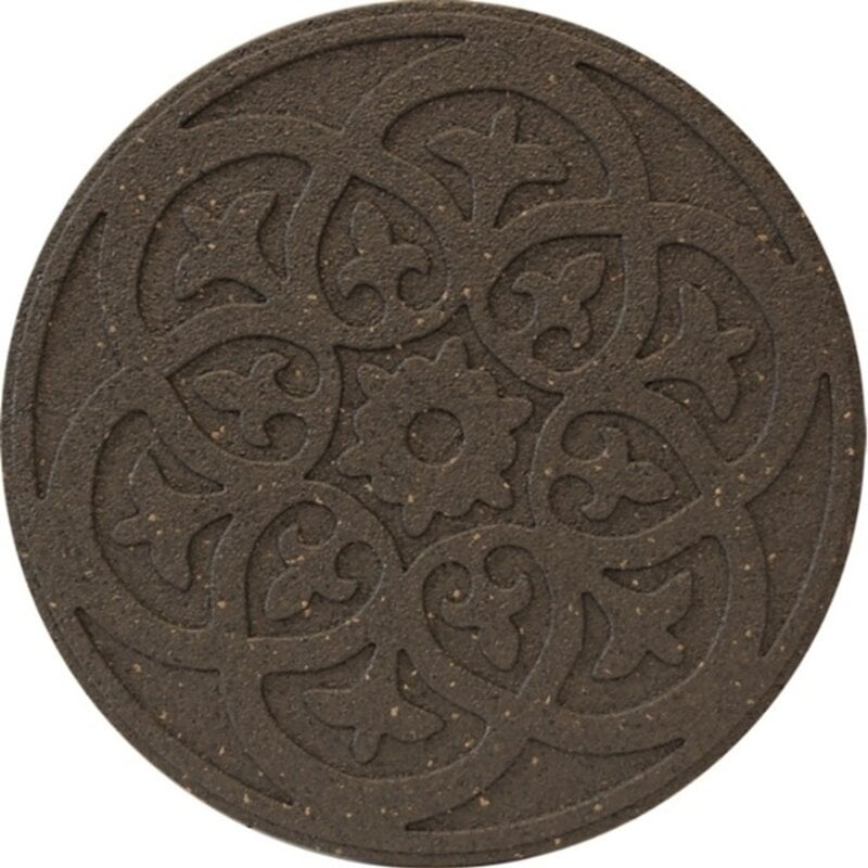 A round, brown reversible stepping stone with a detailed scroll design