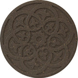 A round, brown reversible stepping stone with a detailed scroll design