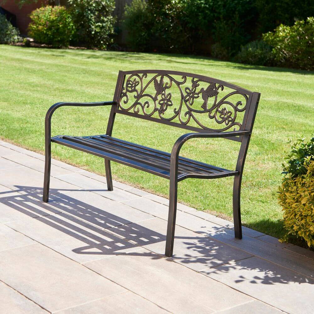 Cast Iron Hummingbird Garden Bench Galvanised Bronze with garden background