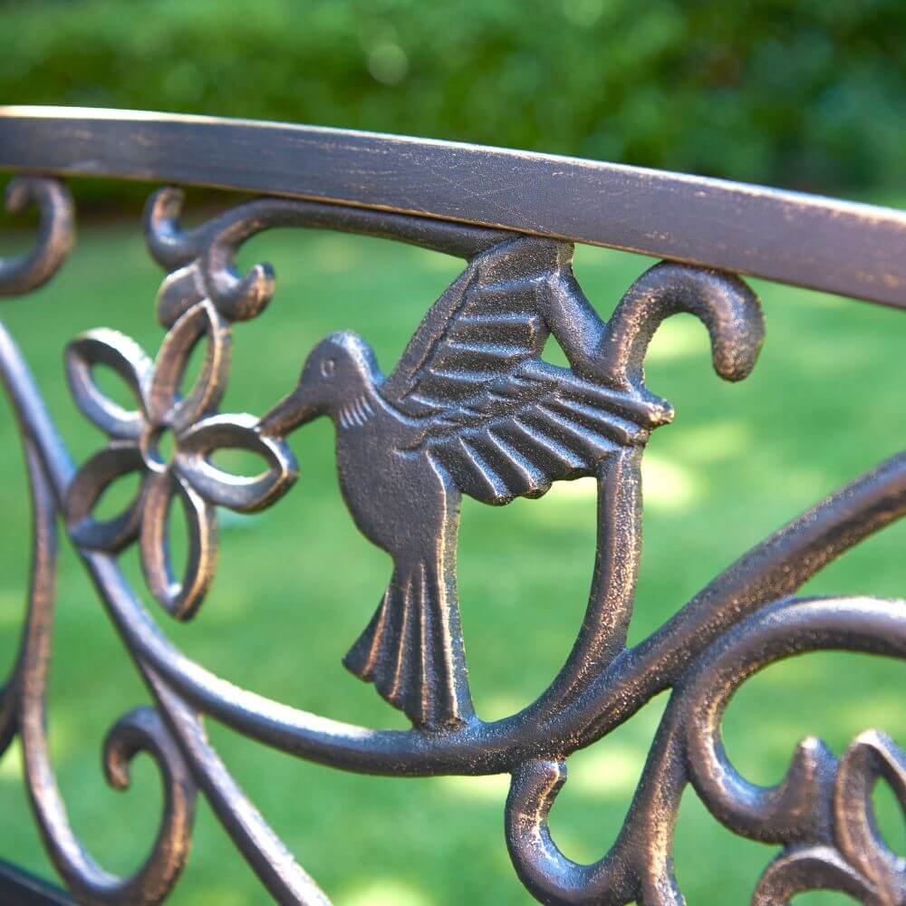 close up of hummingbird garden bench shows precise details of hummingbird and flower