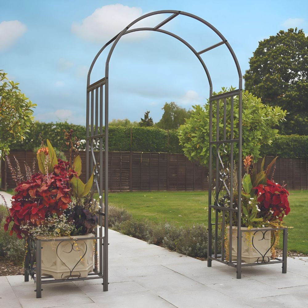 Huntingdon Ornamental Arch with Planter Holders in a colourful garden with a blue sky 