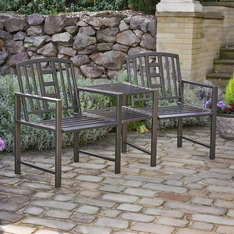 Two metal chairs on a brick patio