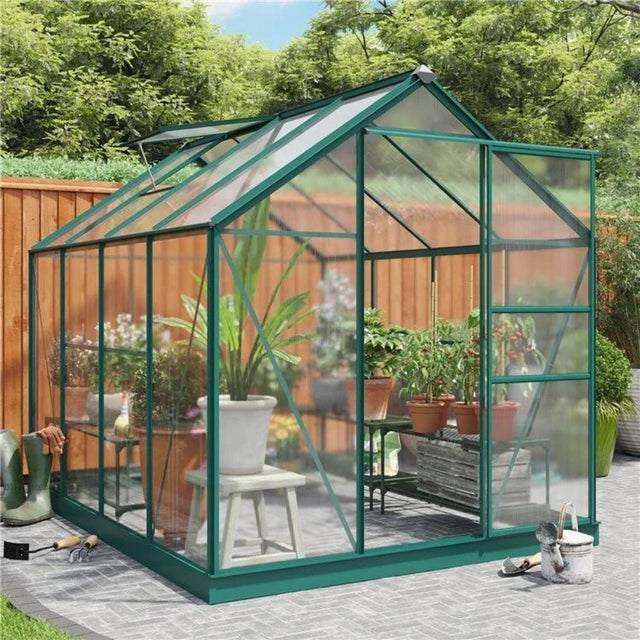 Greenhouse in garden filled with plants and flowers 