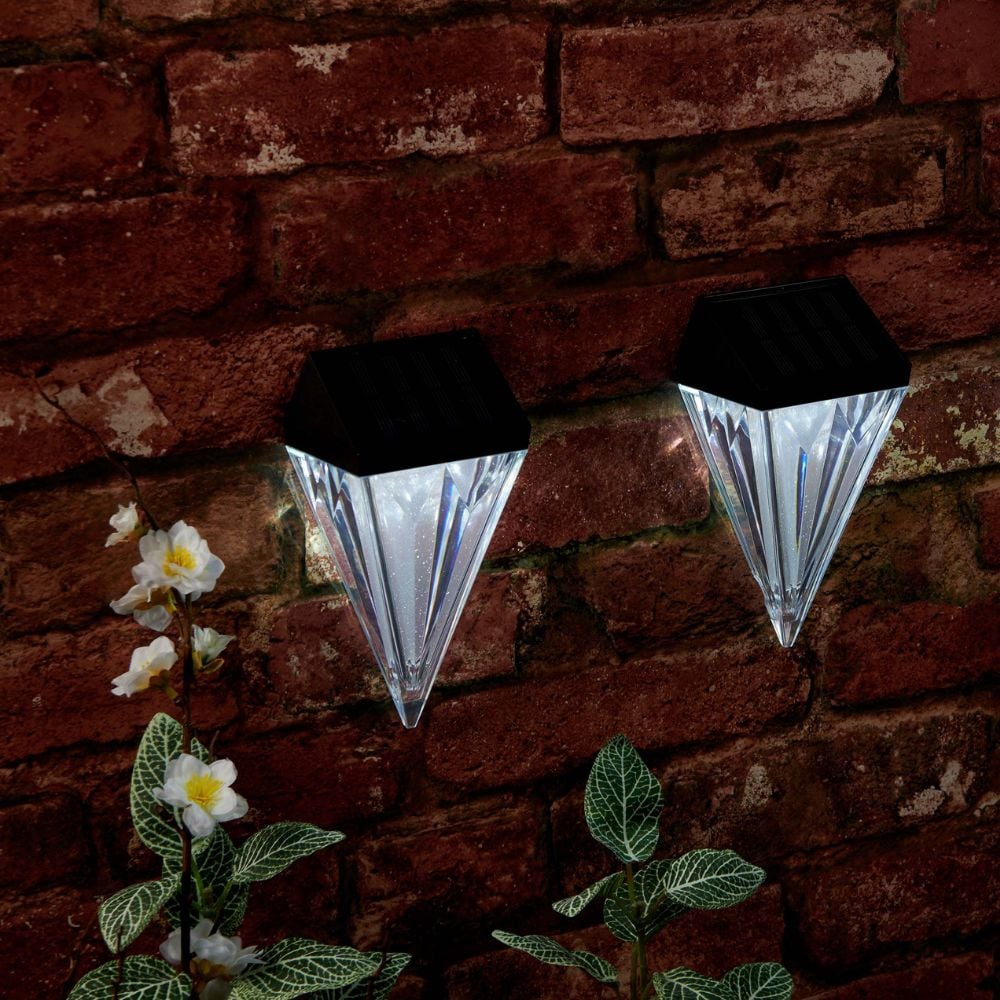 Solar wall lights displayed on brick wall during night time