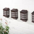 Outdoor wall lights displayed on wall with small solar panel on the top of them