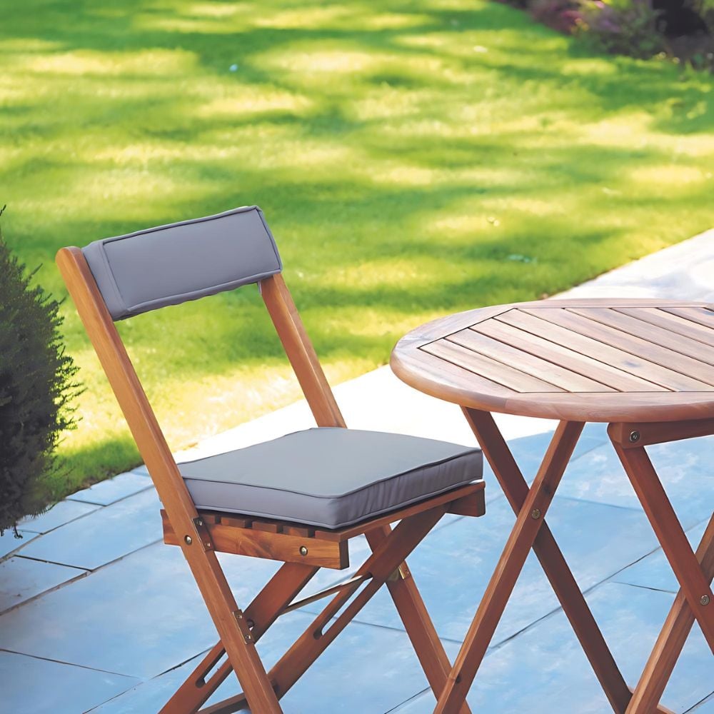 Outdoor dining bistro set with coffee cup on table and two chairs